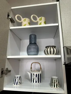 a white shelf with vases and pottery on it at Bohemian Oasis in Casablanca