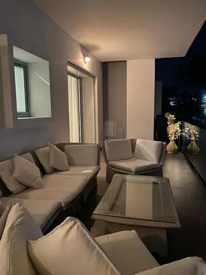 a living room with couches and a table at Pearl Of Eden Island in Bouznika