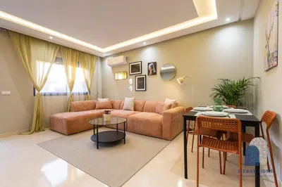 a living room with a couch and a table at Prestige APT Style & elegant RABAT by MERAT HOME in Rabat