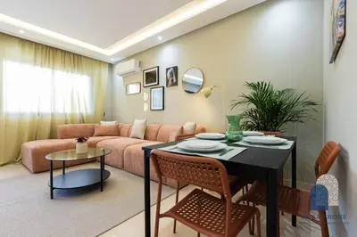 a living room with a table and a couch at Prestige APT Style & elegant RABAT by MERAT HOME in Rabat