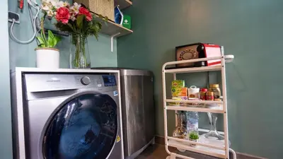 a washing machine in a room with a shelf at Cosy home in Casablanca