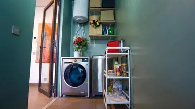 a laundry room with a washing machine and shelves at Cosy home in Casablanca