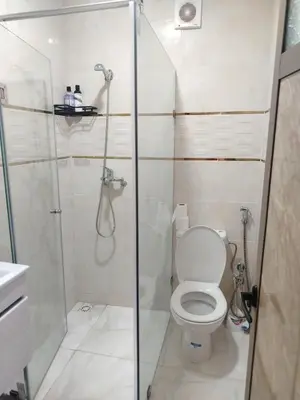 a bathroom with a shower and a toilet at Calme large studio in Casablanca
