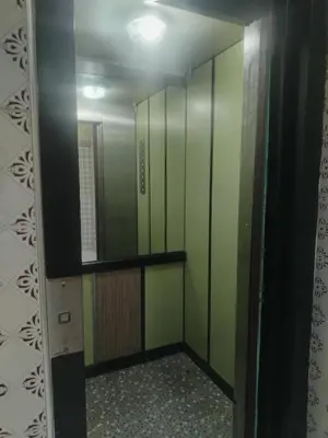 a bathroom with green walls and a mirror at Calme large studio in Casablanca