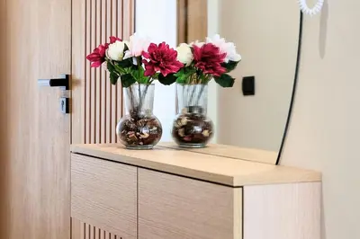 two vases with flowers sitting on a counter in front of a mirror at CFC Modern Studio Emplacement Face à Anfa Park in Casablanca