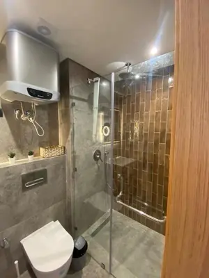 a bathroom with a shower with a toilet and a glass shower stall at CFC Modern Studio Emplacement Face à Anfa Park in Casablanca