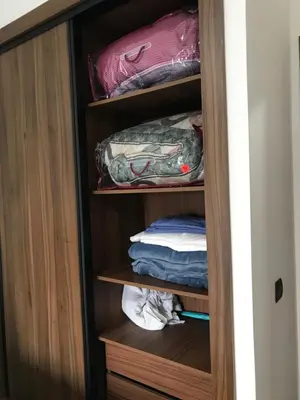 a cupboard with some folded clothes in it at appartement in Mohammedia