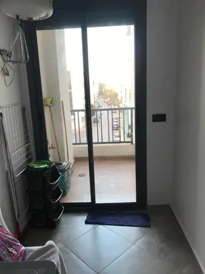 a room with a door open to a balcony at appartement in Mohammedia