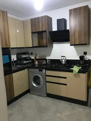 a kitchen with a washing machine and a sink at appartement in Mohammedia