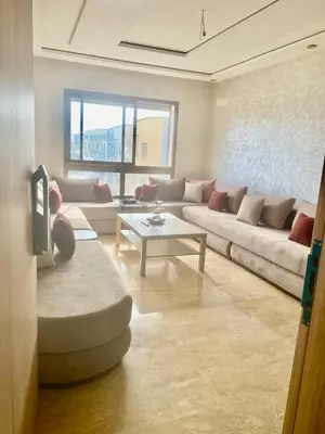 a living room with a couch and a table at Bright & Cozy Apartment in Casablanca