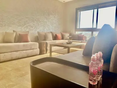 a living room with two water bottles sitting on a couch at Bright & Cozy Apartment in Casablanca