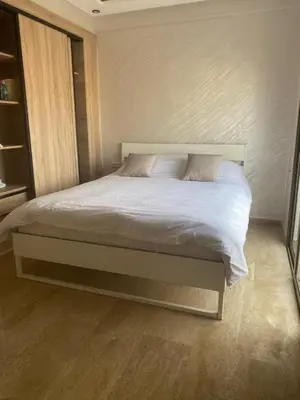 a bed in a bedroom with a white bedvisor at Bright & Cozy Apartment in Casablanca