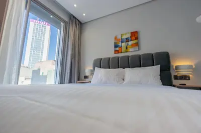 a bedroom with a large bed with a large window at Faya Nova- Appart hotel Central Stay in Casablanca