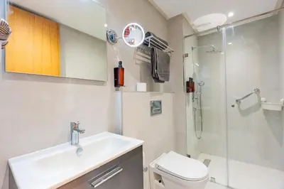 a bathroom with a toilet and a sink and a shower at Faya Nova- Appart hotel Central Stay in Casablanca