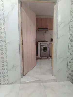 an open door to a kitchen with a washing machine at Très joli appartement à Casablanca in Casablanca