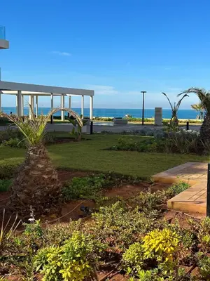 a park with a bench and the ocean in the background at L' Evasion BLeu au Carroussel in Rabat