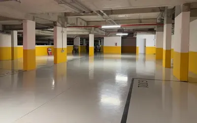 an empty parking garage with yellow and white columns at L' Evasion BLeu au Carroussel in Rabat