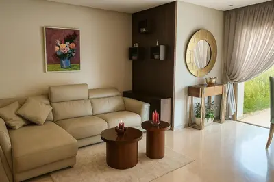 a living room with a couch and two tables at L' Evasion BLeu au Carroussel in Rabat