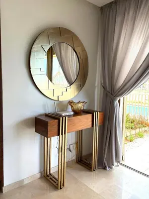 a mirror on a wall next to a table at L' Evasion BLeu au Carroussel in Rabat