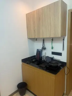 a kitchen with a sink and a stove and cabinets at Modern Studio in Hay Riad All Comfort in Rabat