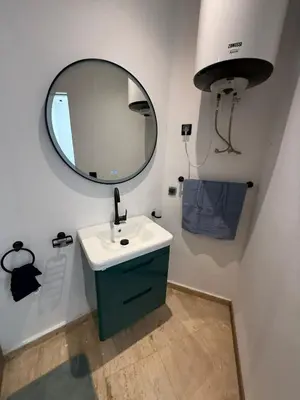 a bathroom with a sink and a mirror at Modern Studio in Hay Riad All Comfort in Rabat