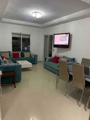 a living room with couches and a flat screen tv at Lovely three sides Appart in Ola Blanca in Sidi Rahal