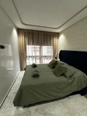 a bedroom with a large bed with a large window at Luxury studio Maarif à 5 min CFC in Casablanca