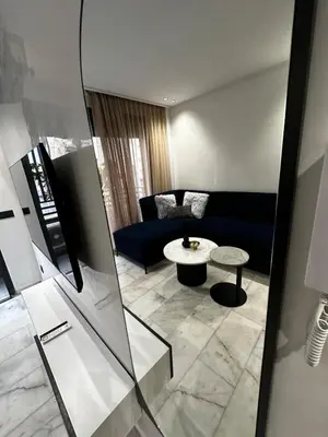a living room with a couch and a table at Luxury studio Maarif à 5 min CFC in Casablanca