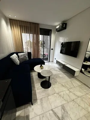 a living room with a couch and a table at Luxury studio Maarif à 5 min CFC in Casablanca