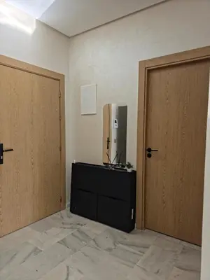 a room with two doors and a tv on a dresser at apartment luxe dt7 in Casablanca