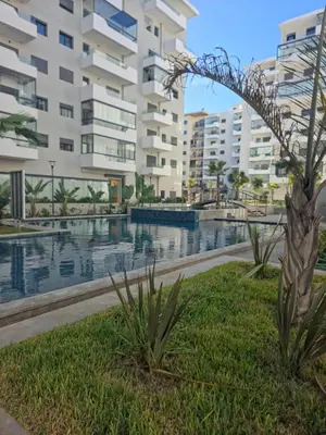 a pool in front of a large apartment building at apartment luxe dt7 in Casablanca