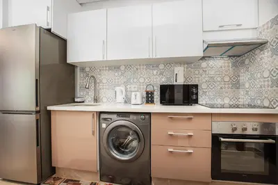a kitchen with a washing machine and a refrigerator at Modern Comfortable Apartment - Corniche Hassan II in Casablanca