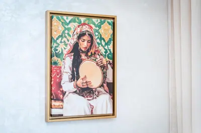 a framed picture of a woman with a banjo at Modern Comfortable Apartment - Corniche Hassan II in Casablanca