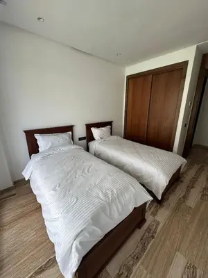 two beds sitting next to each other in a room at Luxurious Apartment with Serene Garden & Private Pool in Casablanca