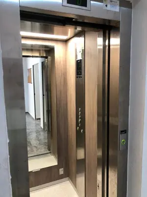 an elevator in a building with a mirror at Cozy Studio with pool, fiber optics in Mansouria