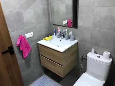 a bathroom with a sink and a toilet and a mirror at Cozy Studio with pool, fiber optics in Mansouria