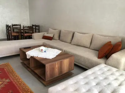 a living room with a couch and a coffee table at Cozy Studio with pool, fiber optics in Mansouria