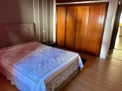 a bedroom with a bed and a wooden door at Casa 2mars Appart lumineux in Casablanca