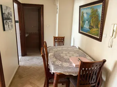 a dining room with a table and a painting on the wall at Casa 2mars Appart lumineux in Casablanca