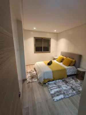 a bedroom with a bed with yellow pillows and a window at Joli Studio Hôpital Cheikh Khalifa in Casablanca