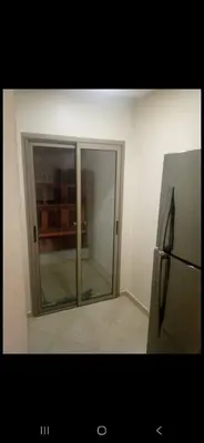 an empty room with a sliding glass door at Joli Studio Hôpital Cheikh Khalifa in Casablanca