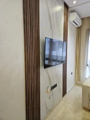 a flat screen tv hanging on a wall at Casablanca premium Suite,wifi,parking in Casablanca