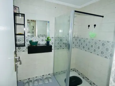 a shower with a glass door in a bathroom at Appartement meuble rabat in Rabat