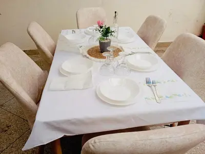 a white table with chairs and plates and flowers on it at Appartement meuble rabat in Rabat