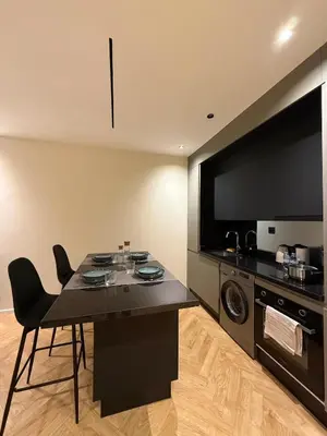 a kitchen with a black table and a microwave at Cozy Modern Studio Near Stadium Mohammed V in Casablanca