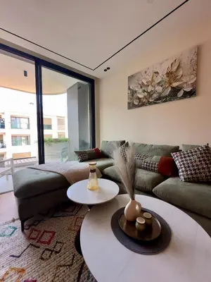a living room with a couch and a table at Cozy Modern Studio Near Stadium Mohammed V in Casablanca
