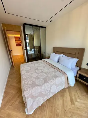 a bedroom with a large bed with white sheets and pillows at Cozy Modern Studio Near Stadium Mohammed V in Casablanca