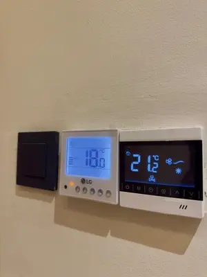 an electronic clock on a wall next to a speaker at Cozy Modern Studio Near Stadium Mohammed V in Casablanca