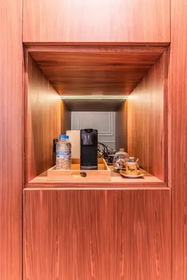 a cabinet with a mirror on a wooden wall at Princesses Luxury Studio - Elegance & Light in Casablanca