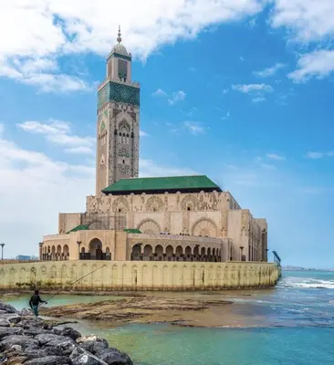 a building with a clock tower next to the water at Bright & cozy studio in Oasis, close to train station in Casablanca